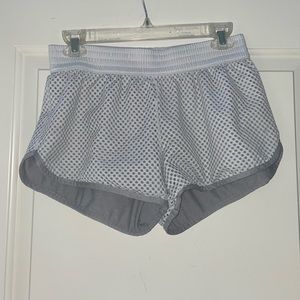 Gray champion laced shorts with holes and stretchy waistband.